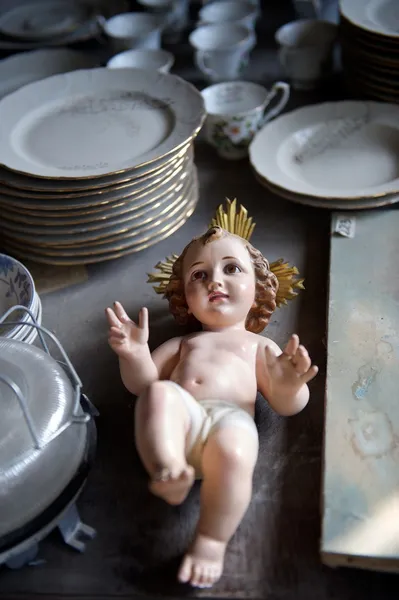 Baby Jesus statuette relegated to an antiques shop