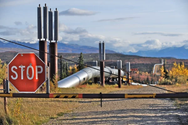 Trans-Alaska oil pipeline with stop sign and closed gate, US