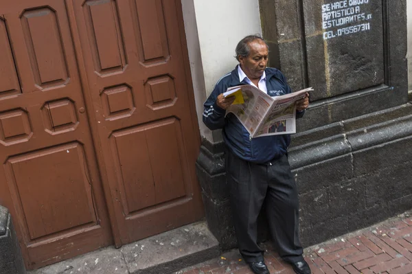 Man reading paper in Quito, Ecuador