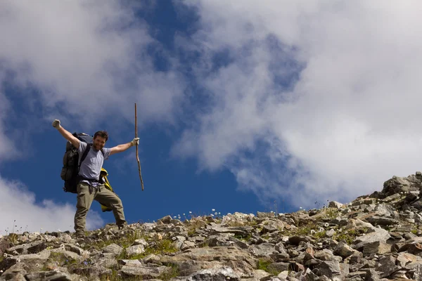 Happy hiker with stick on a background of sky — Stock Photo #31216861