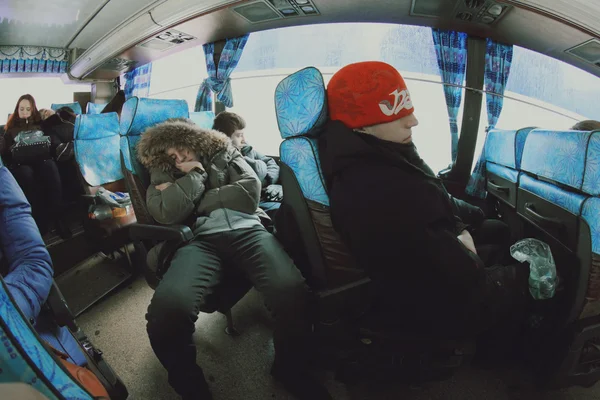 Men sleep in the bus