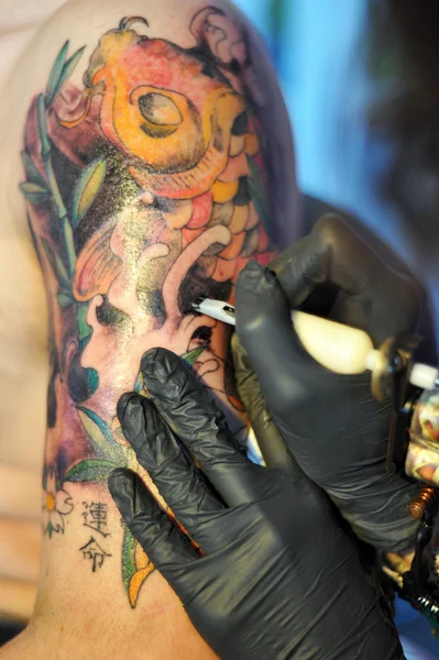 A japanese carp tattoo being made