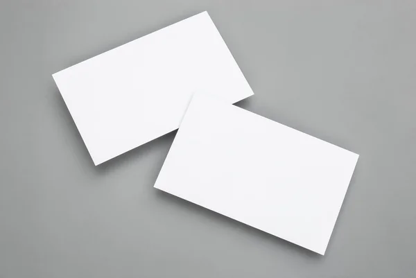 Blank business cards on grey background