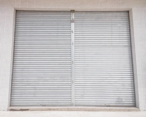 Blank metal shutter doors on commercial shop front