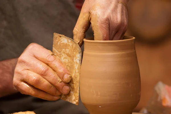 Potter shaping clay