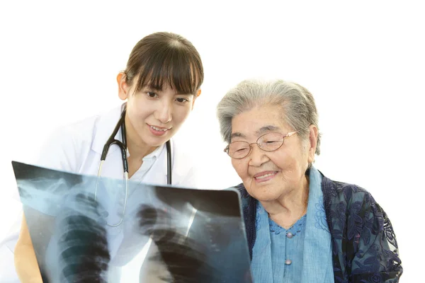 Asian medical doctor and old woman
