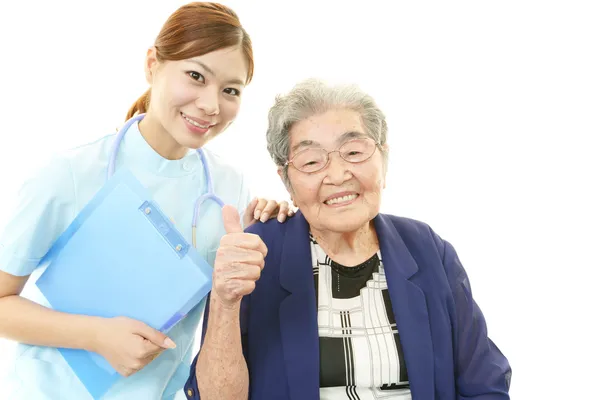 Smiling Asian medical doctor and senior woman