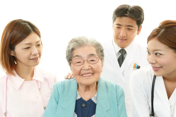 Smiling Asian medical staff with old woman