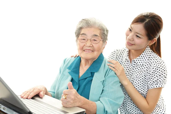 Old woman enjoys computer