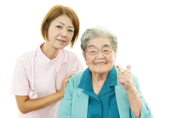 Senior woman with medical staff