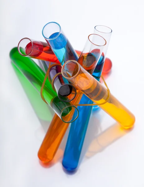 Test tubes with colored liquid in the spectrum colors on a white — Stock Photo #23566325