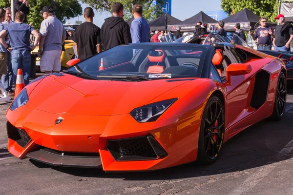 Orange Lamborghini on exhibition parking at an annual event Supe