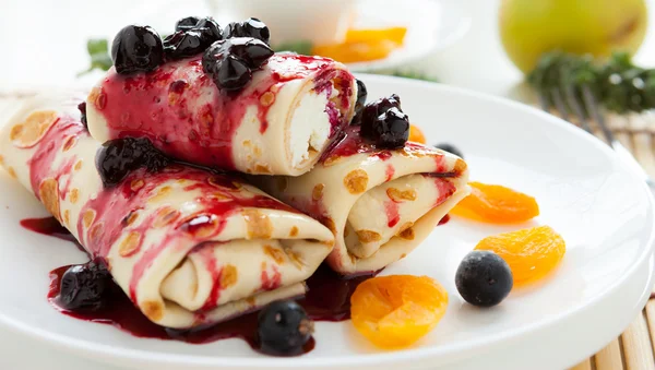 Pancakes with curd and berry sauce