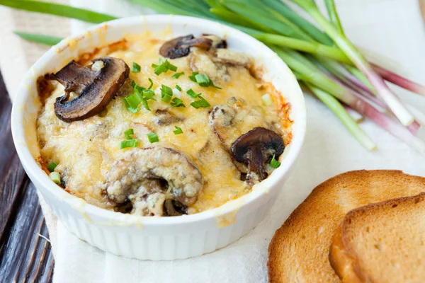 Mushrooms baked in the oven with grated cheese