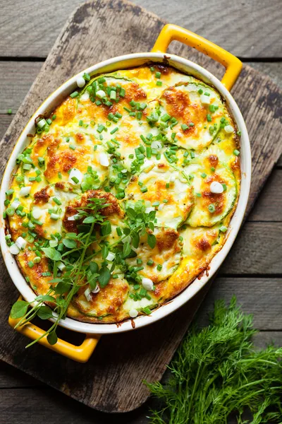 Zucchini baked with cheese in a dish