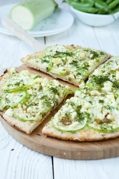 Round pizza with zucchini and cheese