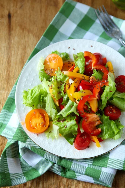 Healthy vegetable salad on plate, top view