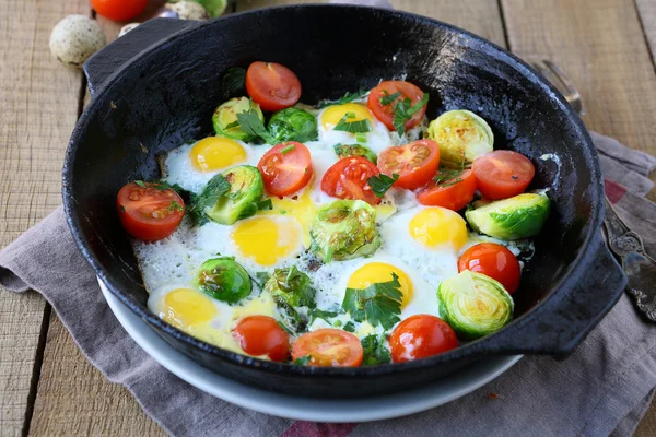 Vegetable fried eggs in a frying pan