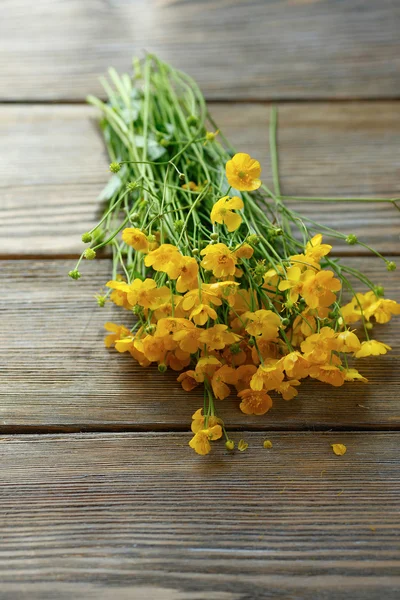 Armful of yellow flowers on the table