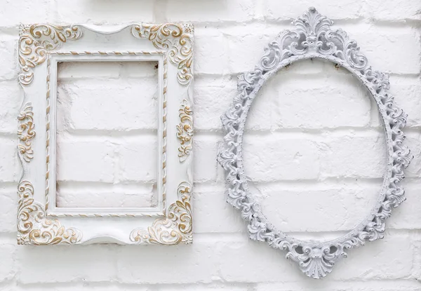 Vintage picture frames on white brick wall background