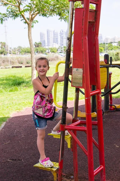 Little girl on street exercise machines