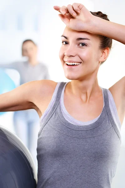 A Woman at the gym wipes the sweat from his forehead comprehensive training