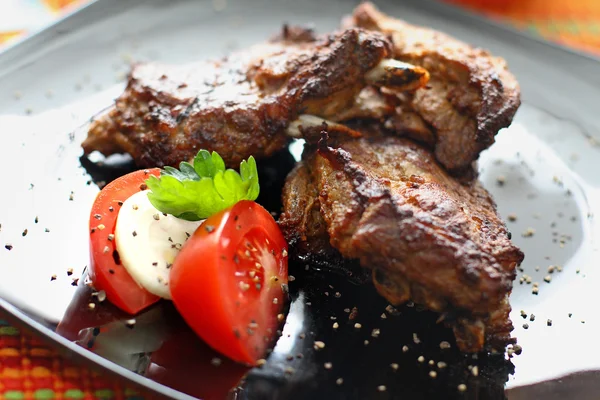 Grilled beef steak with tomatoes and mozzarella.