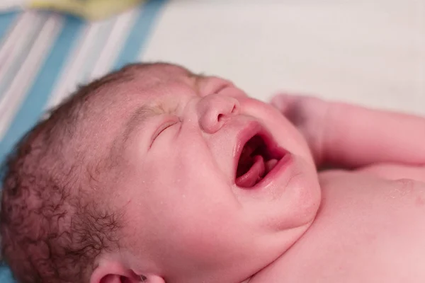 Newborn baby crying in delivery room