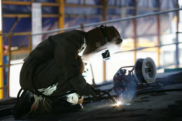 Worker using a welding torch