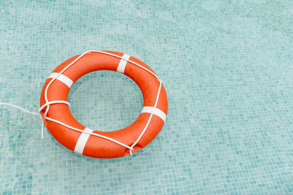 Lifeguard floating in swimming pool