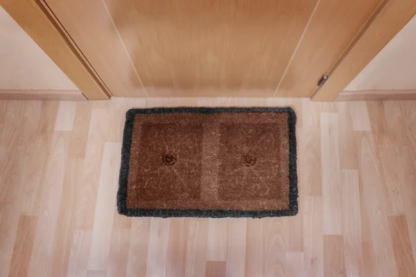 Welcome home doormat with closed door