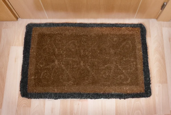 Welcome home doormat with closed door