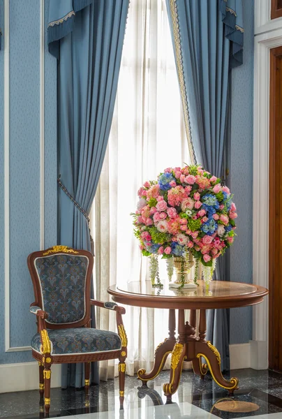 Elegance armchair and flower bouquet on table