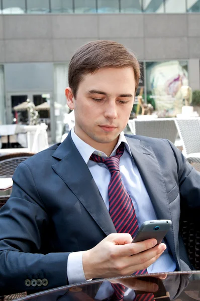 Portrait of a businessman looking at the phone