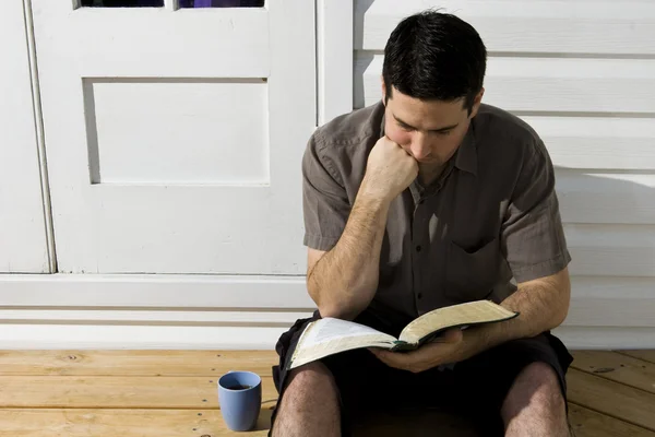 Man thinks as he reads the Bible