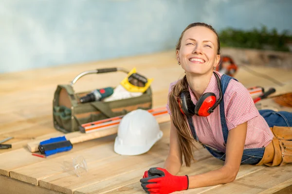 Happy woman builder relaxing after work