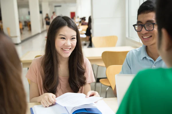 Asian students working in the library.