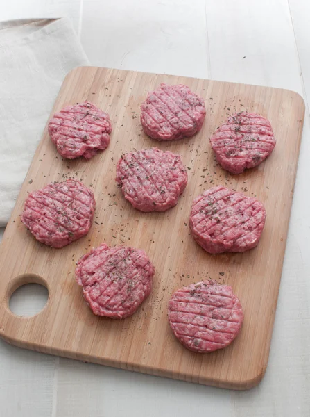 Beef patties round on cutting board top view