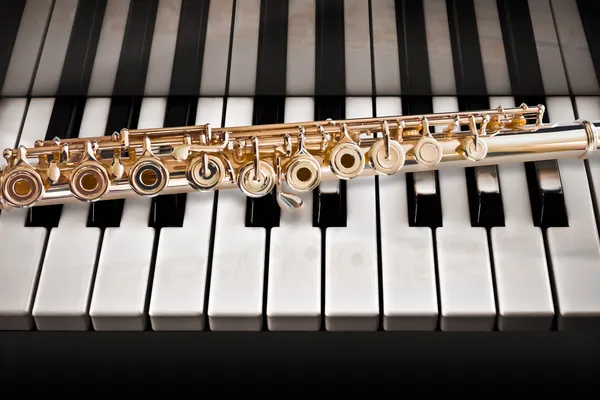 14 K rose gold flute on a piano