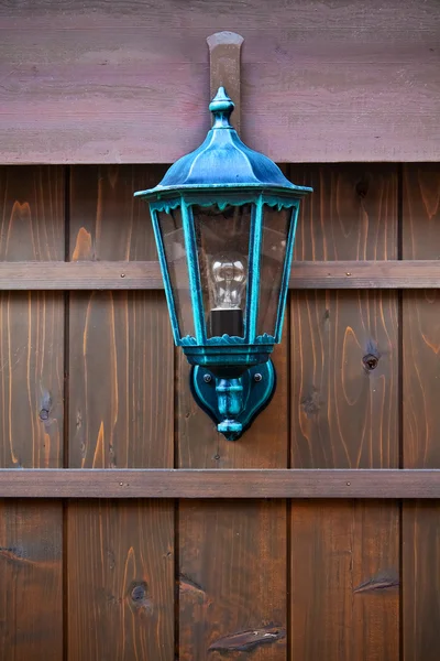 Lamp on a Wood Fence