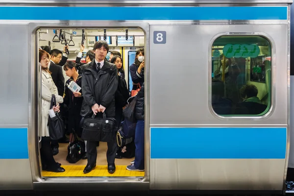 Japanese Commutors on a Train in Tokyo