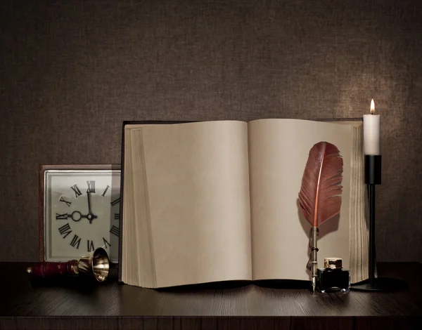 Vintage book, pen, watch and candle