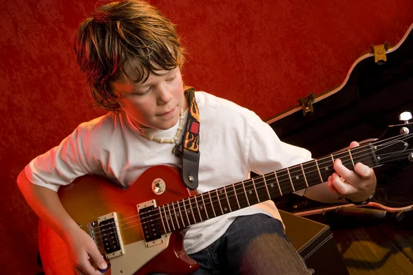 Child rock star plays electric guitar