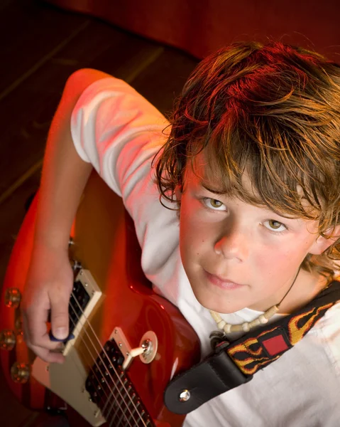 Child rock star plays electric guitar