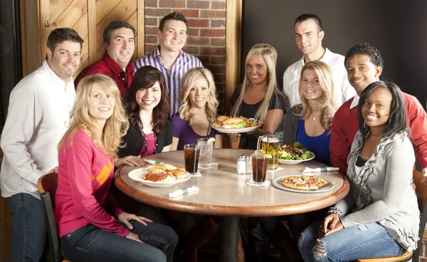 Waist up image of eleven adults at a restaurant