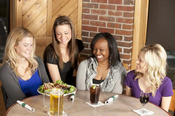 Women enjoying a girl's night out together at a restaurant bar