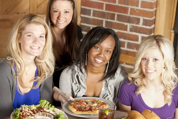 Image of a young adult group of women eating at restaurant