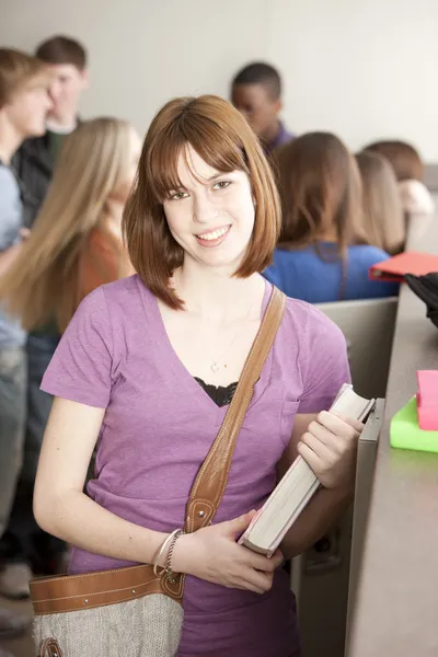 Education. Teenage high school student standing at her locker