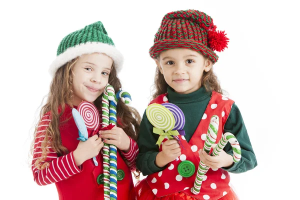 dos pequeños duendes de Navidad sostienen bastones de caramelo y ventosas — Imagen de stock #21427391.