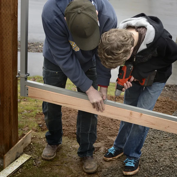 Father and Son Building a Gate
